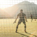 Goalkeeper in front of the goalposts