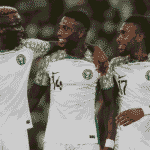 Football players celebrating on the pitch.