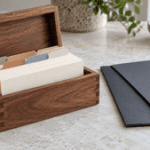 Index cards organized in a wooden box beside folders